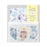 A refreshing stationery design based on blue, sprinkled with sea motifs such as coral, shells, and seaweed. On the writing side of the stationery, an otter's image is depicted floating comfortably on the sea. The adorable sea otter's sticker holding a shell or making a cute upward glance will make your cheeks soften