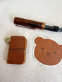 This mini leather journal can be used as a keychain or to keep small notes! There is a tiny notebook inside that is fountain pen friendly. Comes with 1 leather journal - 1 phone charm