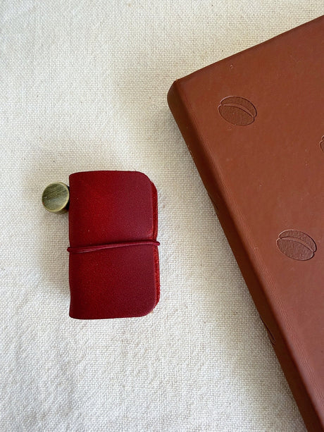 This mini leather journal can be used as a keychain or to keep small notes! There is a tiny notebook inside that is fountain pen friendly. Comes with 1 leather journal - 1 phone charm