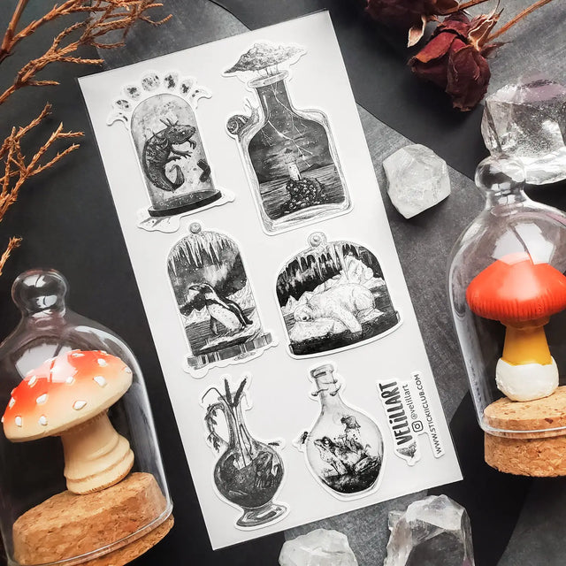 STICKII - Mysterious Little Worlds Sticker Sheet

🌩️🐻❄️ Something strange is brewing in @velillart's bottled-up world of wonders! Featuring a lighthouse amidst a storm, polar dreams of ice, and the curious lives of snails, frogs, and a mystical axolotl. This sheet feels like a cabinet of bottled curiosities gathered by a traveler who’s seen places no map could ever capture. Art by: @velillart

Top Coating: None
Adhesive Layer: Paper
Backing Layer: Clear PET
6.69"x3.54"
Weight: 0.03oz
1 Sheet Included