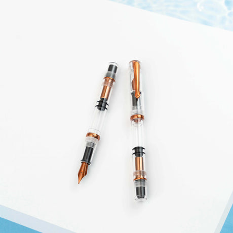 The Original: Summer follows in the footsteps of the provenly popular Original: Spring. Made out of a clear acrylic, the only colored parts of the pen are the: clip, ring, piston and nib. These components have been plated in a bright coppery orange. As always, the Original: Summer uses our in house stainless steel nibs and this demonstrator has a full view of the piston filling system.