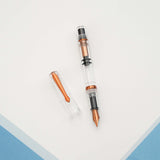 The Original: Summer follows in the footsteps of the provenly popular Original: Spring. Made out of a clear acrylic, the only colored parts of the pen are the: clip, ring, piston and nib. These components have been plated in a bright coppery orange. As always, the Original: Summer uses our in house stainless steel nibs and this demonstrator has a full view of the piston filling system.