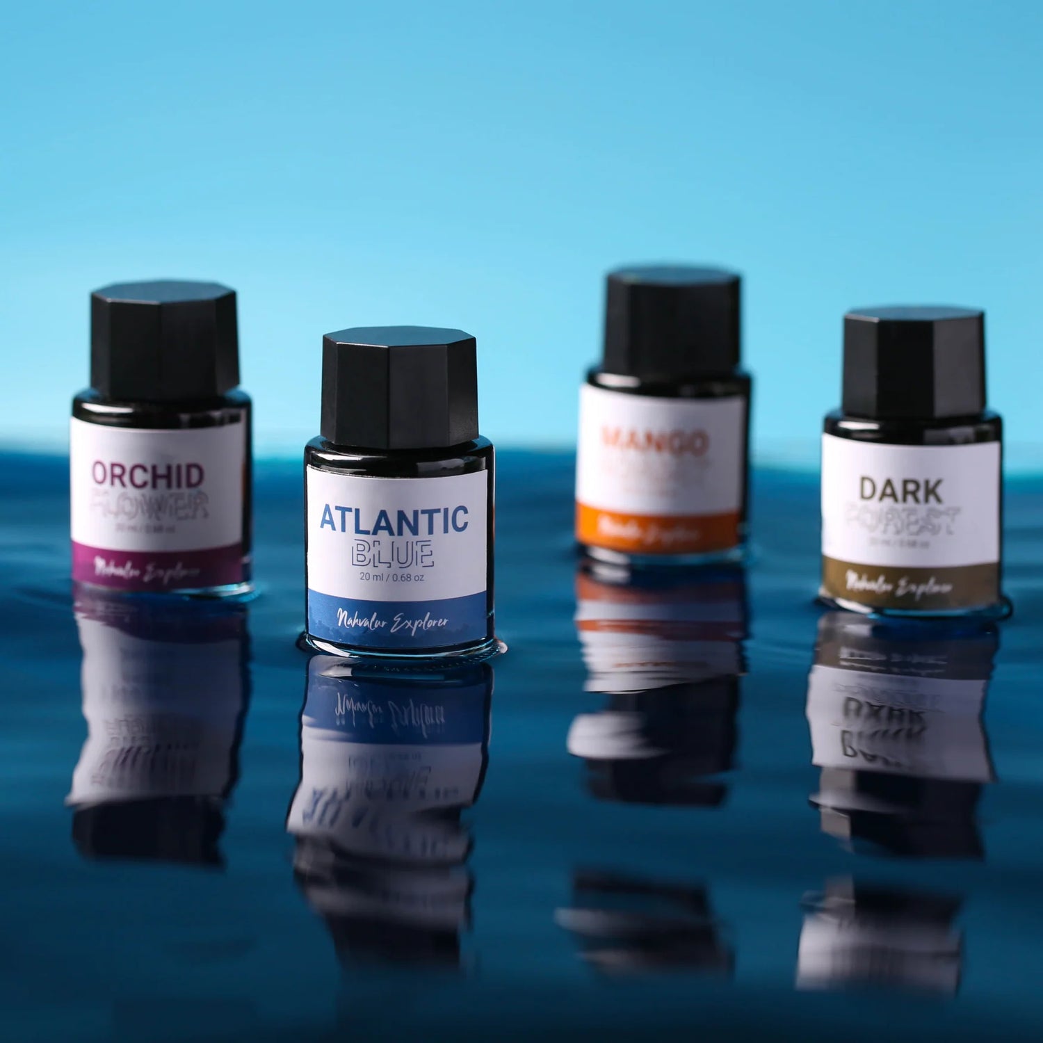 The new Nahvalur Explorer ink collection is comprised of four fountain pen inks—Dark Forest, Atlantic Blue, Orchid Flower, and Mango Sorbet—each inspired by one of the original Nahvalur Explorer Plus fountain pens. The box packaging features a lighthouse illustration in the ink color. The 20-ml round glass bottles have a hexagonal cap, and inks are pH neutral and fast drying.