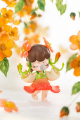 Nanci Flower Stories Figure Dolls Blind Box Figurine of a girl with flowers in her hair surrounded by orange flowers and green leaves on a white background