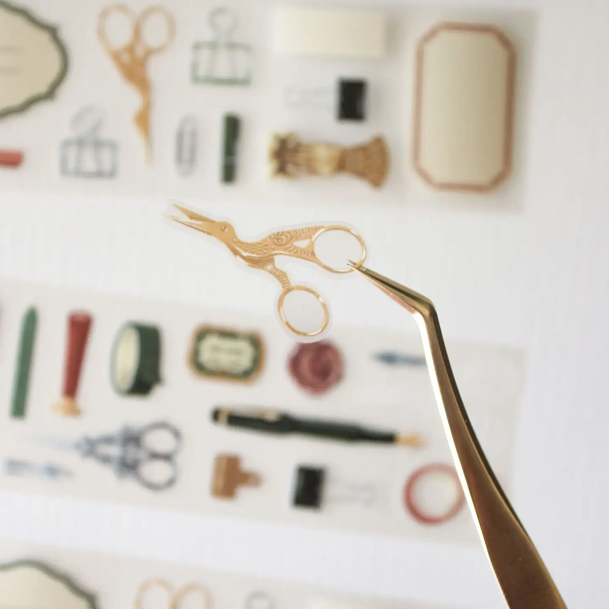 An updated version of our Stationery Essentials PET tape, now with a longer 50cm designer loop for even more creative possibilities.

This PET tape features hand-painted illustrations of vintage stationery such as wax seal stamps, fountain pens and ornate scissors. Designed by Rebecca and pre-cut for effortless use, it's perfect for journaling, collaging and adding a vintage aesthetic to any creative project.

Extra wide at 50mm with a matt transparent finish that layers cleanly over any background. No scis
