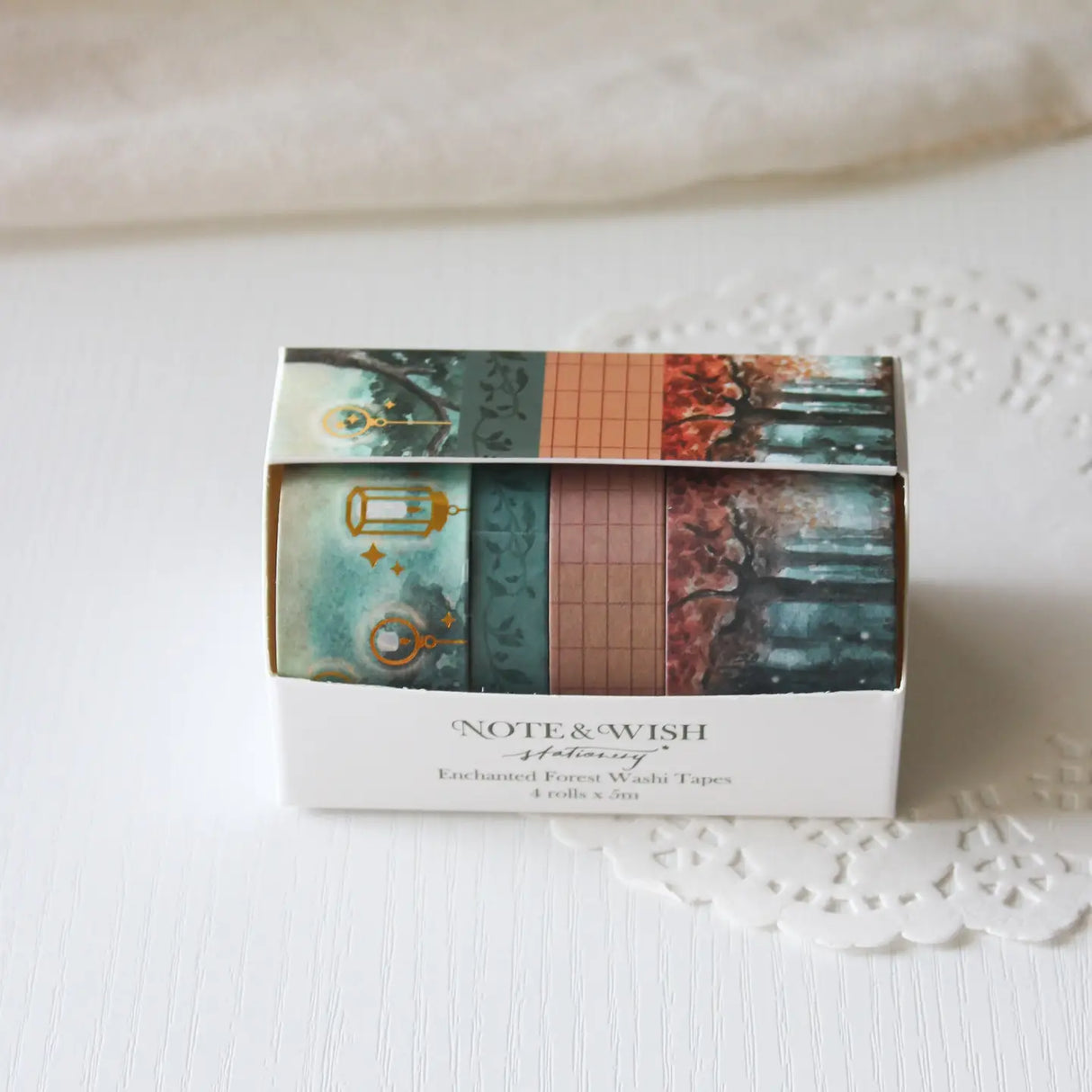 This enchanted forest washi tape gift set is designed for dreamers, storytellers, and stationery lovers who enjoy woodland walks at dusk. Featuring hand-painted watercolour forest scenes by Rebecca. Perfect for journaling and anyone who loves bringing the beauty of the British countryside into their creative projects.

30mm x 5m - Forrest
25mm x 5m with gold foil - Lanterns
5mm x 5m - Foliage
10mm x 5m - grid