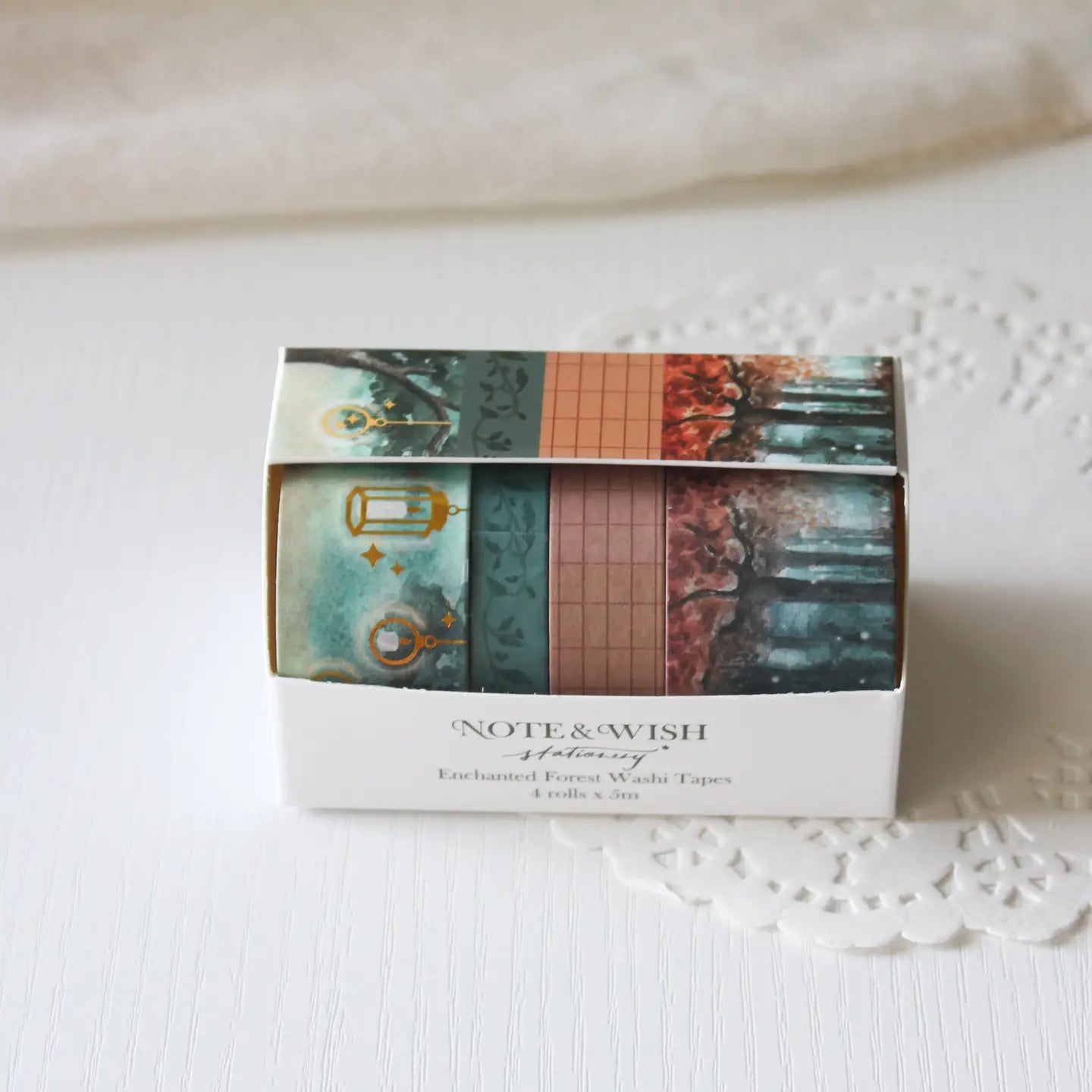 This enchanted forest washi tape gift set is designed for dreamers, storytellers, and stationery lovers who enjoy woodland walks at dusk. Featuring hand-painted watercolour forest scenes by Rebecca. Perfect for journaling and anyone who loves bringing the beauty of the British countryside into their creative projects.

30mm x 5m - Forrest
25mm x 5m with gold foil - Lanterns
5mm x 5m - Foliage
10mm x 5m - grid