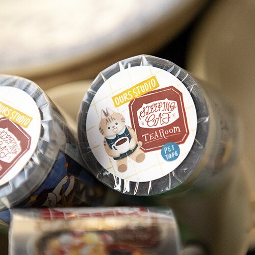 Welcome to the Tea Room! This kiss-cut PET Tape features a relaxing teahouse filled with cats and other furry friends. It adds the perfect touch of warmth to your journal pages with hints of golden brown and dark blue as conversations continue until midnight.