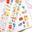 This PET tape is kiss-cut for your convenience. The tape is made of a thin, matte, clear material that is great for journaling! The theme of the tape is a play on the word homebody so all of the stickers are related to the home or activities you do at home.