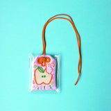 2x2.5 omamori charm with a 8 inch string.

An omamori is a Japanese charm that provides protection and luck!