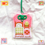 2x2.5 omamori charm with a 8 inch string.

An omamori is a Japanese charm that provides protection and luck!