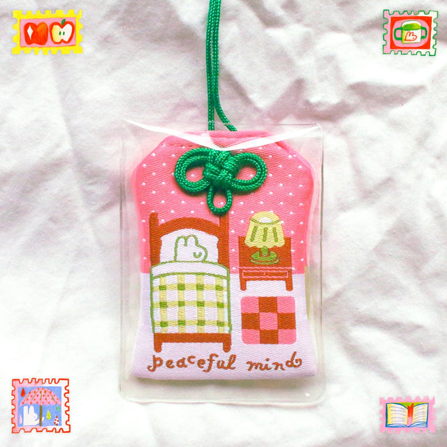 2x2.5 omamori charm with a 8 inch string.

An omamori is a Japanese charm that provides protection and luck!