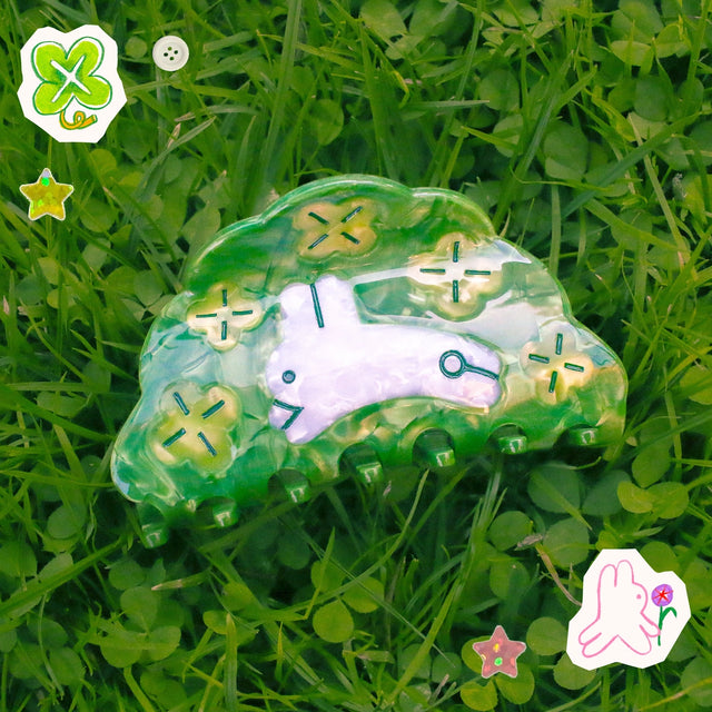 Clover Hair Claw featuring a little rabbit leaping through a field of clover.

Made of acetate, 3.5 inches long.&nbsp;