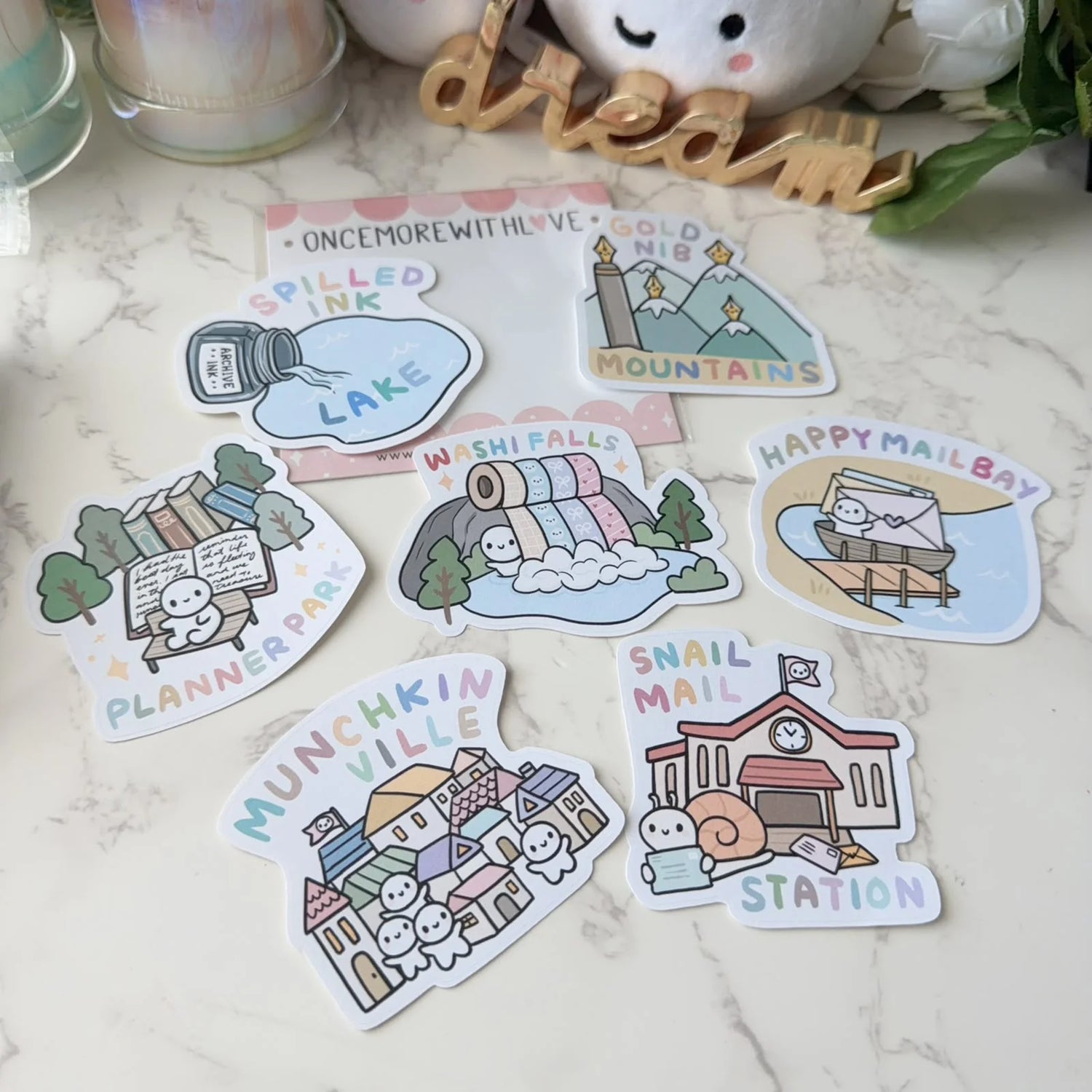A whimsical and heart‑warming addition to any sticker lover’s collection, the Munchkinland Sticker Pack from Once More With Love brings adorable charm to planners, journals, scrapbooks, and creative projects. Featuring cute, expressive characters inspired by the magical world of Munchkinland, this vinyl sticker set is perfect for adding personality and joy to your everyday spreads.

Includes 7 Stickers