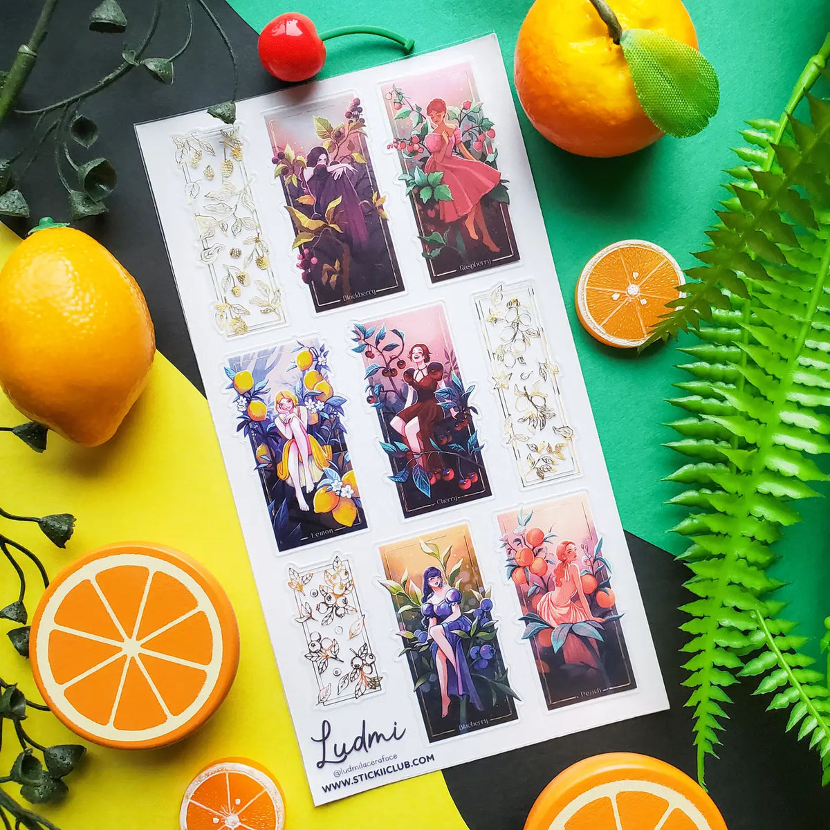 🍒🍋 @ludmilacerafoce’s fruity fashionistas are serving looks inspired by blackberries, raspberries, lemons, cherries, blueberries, and peaches! Draped in juicy colors and surrounded by oversized fruit and foliage, each glamorous girl brings her own bold personality to the garden. Finished with gleaming foil accents, this sheet is one seriously fresh-picked lineup! Art by: @ludmilacerafoce

Top Coating: Gold foil
Adhesive Layer: PVC (plastic)
Backing Layer: Clear PET
6.69" x 3.54".
Weight .03lbs