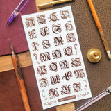 STICKII - Ornate Alphabet Sticker Sheet

✒️📜 Add a touch of old-world elegance to your pages with this ornate alphabet sheet. Inspired by gothic lettering, vintage monograms, and illuminated manuscript details, each letter is full of curling flourishes and antique charm. Perfect for spelling out initials, decorating journal pages, labeling letters, or giving any paper project the feeling of something pulled from a beautifully aged book.

Top Coating: None
Adhesive Layer: Paper
Backing Layer: Paper
6.69" x 