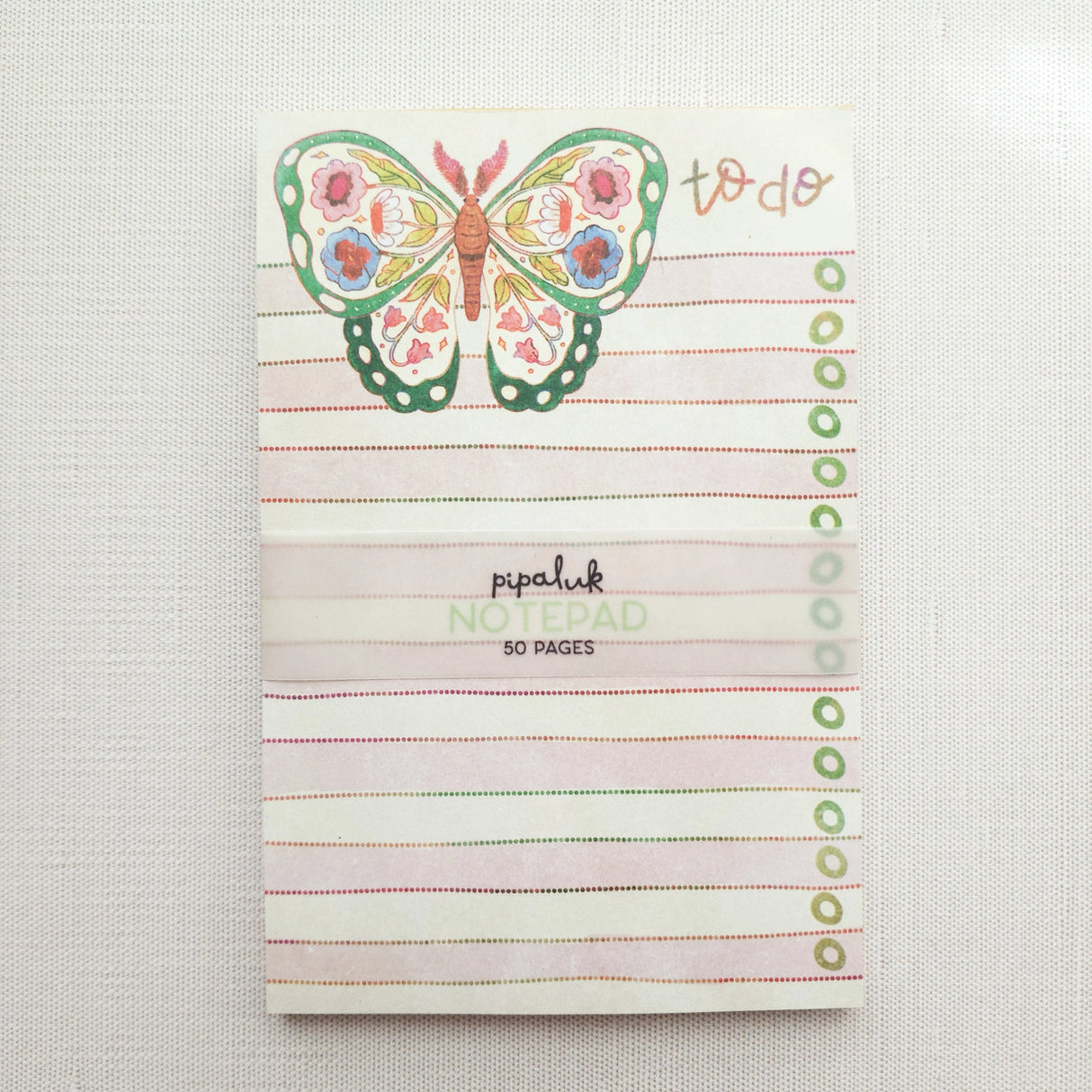 In the gardens of Wildflower Woods, a butterfly drifts from bloom to bloom, wings patterned with flowers gathered along the way. This notepad brings that light, floral moment to your desk, making everyday lists feel a little more inviting.

Designed to be practical without feeling busy, this notepad offers a simple, cheerful way to keep track of daily to-do lists and planning.