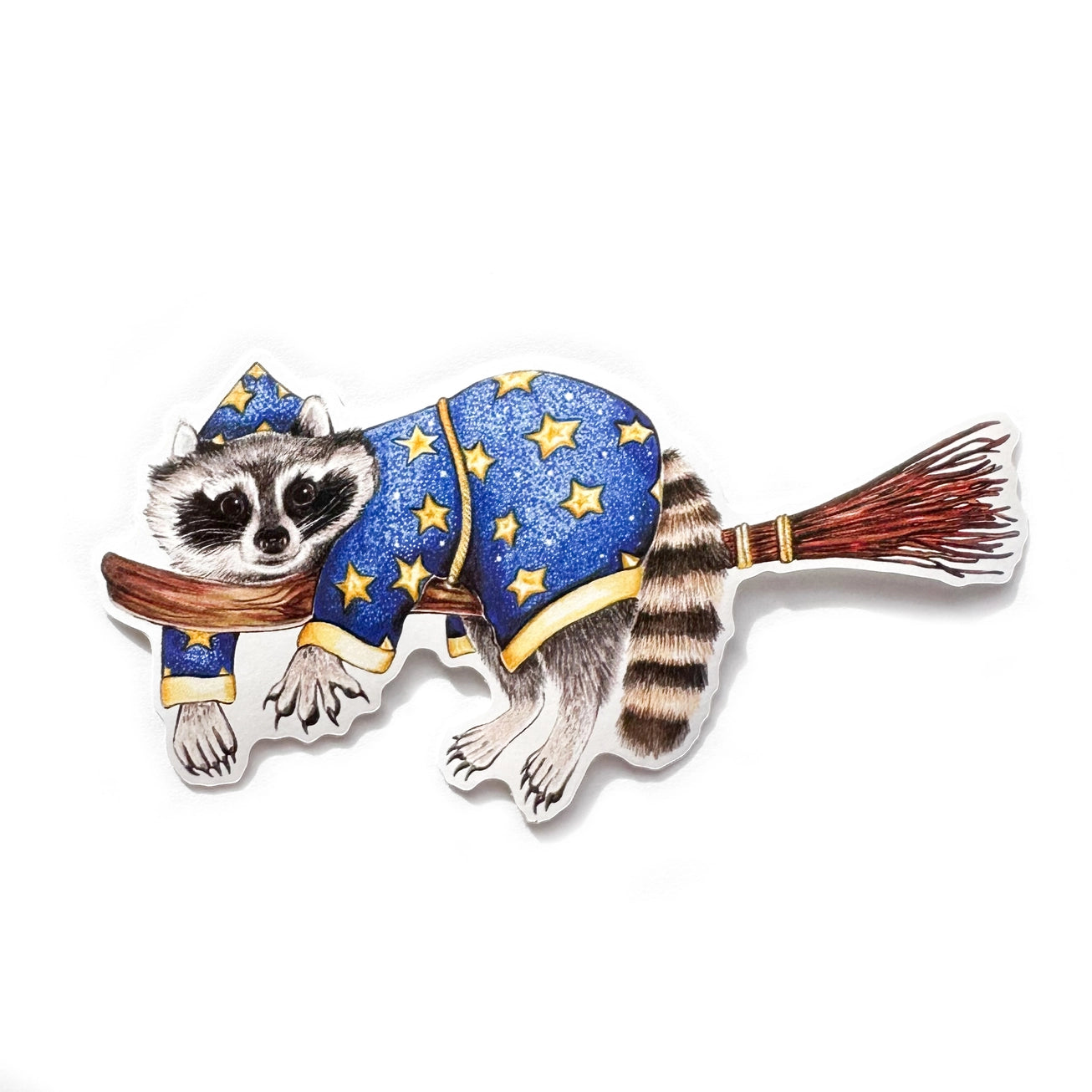A sticker with my illustration of a wizard raccoon riding on a broom.

This die-cut vinyl sticker is durable and perfect for water bottles, notebooks, laptops, bikes, and all sorts of other surfaces! Make sure to clean and dry the surface thoroughly before applying.