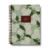 Our softcover spiral planner features a canvas paper cover printed with Hydrangea florals and a gold foil year. Inside you’ll find monthly and weekly views, plenty of space for notes, a list of celebrations, and pockets for storage.&nbsp;

DETAILS

Printed in full color with foil stamped year
Canvas paper cover with white text paper interior
January 2027-December 2027
Monthly and weekly views
Space for notes each week
List of celebrations
Pockets for storage
Spiral bound

6.25" W x 8.5" L