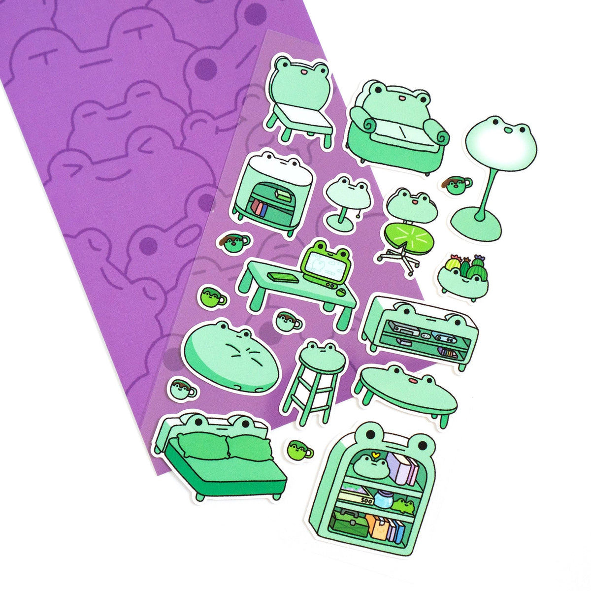 This is part of a new series of sticker sheets that feature different "days".

There are 20 individual stickers on the sheet full of frog furniture.

They are vinyl stickers on a clear plastic sheet with a backing card.

The whole packaging is 3.8 x 8.75" and is ready to hang.
The sticker sheet is 3.75 x 5.8"