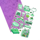This is part of a new series of sticker sheets that feature different "days".

There are 20 individual stickers on the sheet full of frog furniture.

They are vinyl stickers on a clear plastic sheet with a backing card.

The whole packaging is 3.8 x 8.75" and is ready to hang.
The sticker sheet is 3.75 x 5.8"