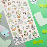 💧🌱 Spring is here, and a sprinkle of rain has brought @wooqiart’s kawaii garden to life! Cuties in froggy hoods and sprouty hats step out to enjoy the season among happy garden friends. With pastel raindrops, leafy umbrellas, and fresh flowers, we wish every drizzly day could be this adorable!
