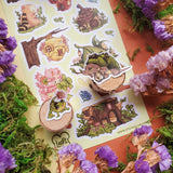 🐛🏡 @loafi_doodles’ cozy crew is living the woodland dream with stump houses, leafy cottages, acorn roofs, and blossom-filled hideaways tucked between clovers and berries. This sheet is basically a house tour for anyone who’s ever wanted to move into a mossy log and never answer emails again. 10/10, would sign the tiny lease.

Art by: @loafi_doodles

• One sticker sheet is included.
• Top Coating: None
• Adhesive Layer: Paper
• Backing Layer: Clear PET
• 6.69"x3.54"
• Weight-0.03oz
• 1 Sheet Included