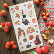🐹🍎 In @anikeru’s whimsical corner of the woods, autumn’s bounty is gathered by the sweetest of friends. A dapper black cat carries fresh berries, mice and hamsters tuck into plump fruits and seeds, and a toad carries treasures on its back. It’s a season painted in warmth, where every creature has a story to share.