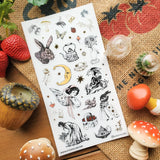 🐇🫖 Somewhere between an old garden journal and a moonlit tea party, @knstartstudio’s enchanting sheet features rabbits in little outfits, winged maidens, buzzing bees, mushrooms, strawberries, roses, and ornate teapots. It’s cottage life with a hint of folklore, perfect for anyone who loves their farmhouse days served with tea leaves, wildflowers, and a little moonlight.

Art by: @knstartstudio

One sticker sheet is included.
• Top Coating: Gold foil
• Adhesive Layer: Washi
• Backing Layer: Clear PET
• 6.