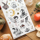 🐇🫖 Somewhere between an old garden journal and a moonlit tea party, @knstartstudio’s enchanting sheet features rabbits in little outfits, winged maidens, buzzing bees, mushrooms, strawberries, roses, and ornate teapots. It’s cottage life with a hint of folklore, perfect for anyone who loves their farmhouse days served with tea leaves, wildflowers, and a little moonlight.

Art by: @knstartstudio

One sticker sheet is included.
• Top Coating: Gold foil
• Adhesive Layer: Washi
• Backing Layer: Clear PET
• 6.