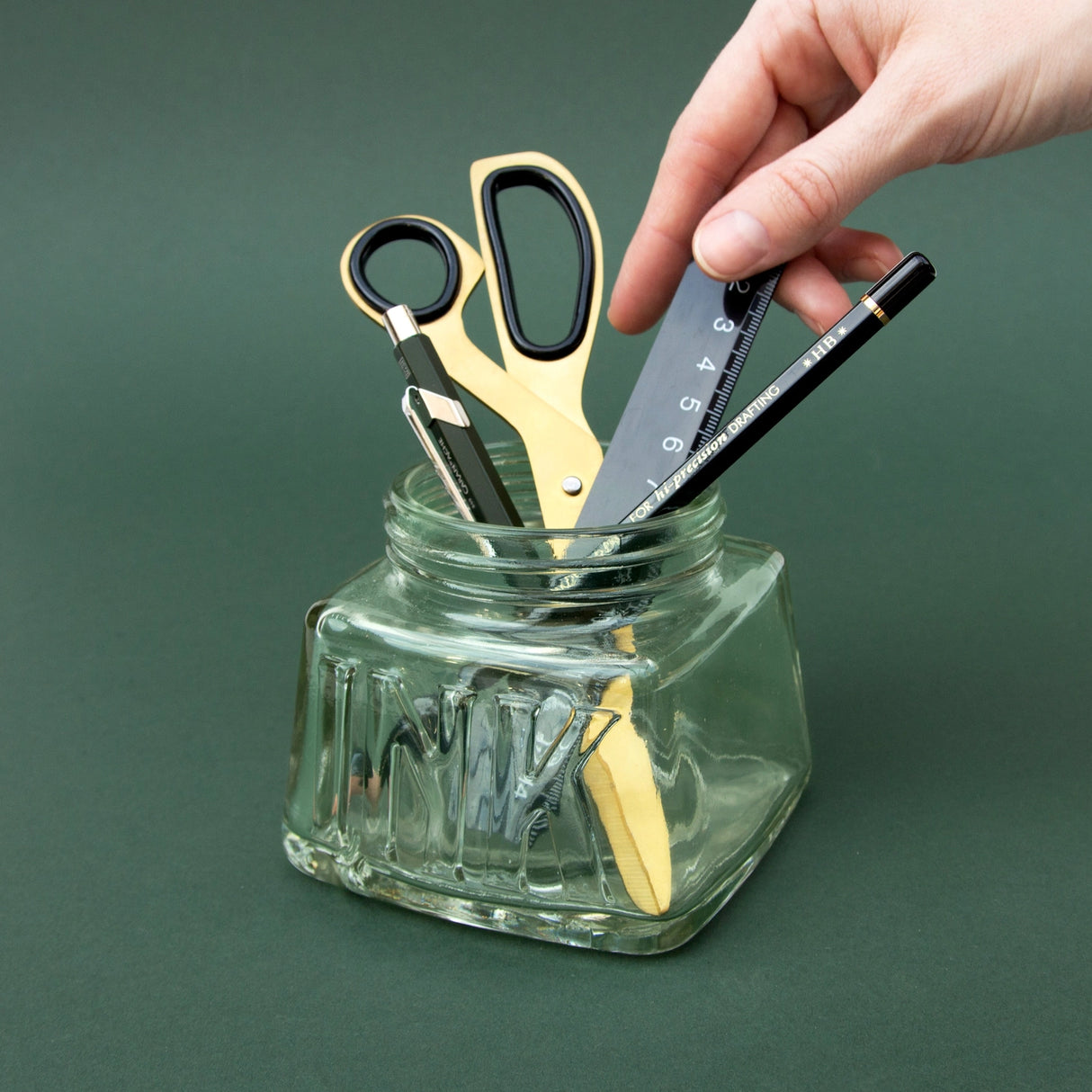 An oversized pen pot designed in the style of a classic inkwell. Made from green-tinted soda glass with plenty of space for your writing tools.

Classic glass pencil pot.
Green tinted soda glass.
Organize your writing tools.
Modern take on a timeless classic.
Pretend you are a Victorian scholar.
Plastic free product and packaging