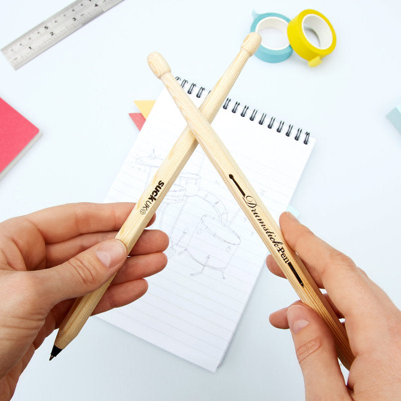 For desk drummers, restless tappers &amp; future rock legends. A pair of drumsticks cleverly disguised as pens, ready for meetings, maths lessons or impromptu solos on the nearest tabletop. Perfect for anyone convinced they're the next Phil Collins. Practice your paradiddles, look busy at work, then get back to annoying the neighbours. Smaller than a drum kit, cheaper than a drum kit, and considerably easier to fit in a pencil case. A great gift for fidgety fingers.

Black Ink
Ballpoint pens shaped like dru