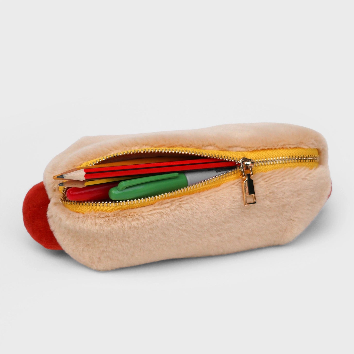 Store stationery or other small items 
Plush hot dog shaped case with gold zip. Store your belongings in style by filling your hot dog bun full. Yum!

Plush Zip Pouches designed and made by SuckUK
Juicy, tasty, sweet and sour. And very cute. Stuff your stuff into something soft, and squishy. Delicious looking plush zip pouches look like foodie treats but instead of calories, they hold your everyday essentials. From cheesy slices to sickly treats, each pouch is designed to be irresistible and practical. Perf
