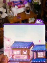 Sakuradragon - Sakura Street A6 Pencil Board

A napping Sakuradragon perched onto of a cozy little shop Sakura Street. It's almost as if she is sleeping on top of your notebook.

What is a pencil board?
Pencil boards are inserts for your notebook that sit under the page you are writing on. They prevent indents on the next page when you write and even prevent ink from bleeding through to the page beneath. But honestly, they can just be cute bookmarks.
