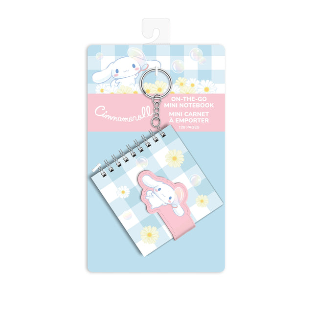 Bring a little sunshine wherever you go with this Cinnamoroll™ On-the-Go Mini Notebook! Compact and adorable, this 3.5" × 3.5" journal features 60 lined pages, a secure strap closure, and a key chain attachment—perfect for quick notes, doodles, or gifting to your favorite Sanrio fan.