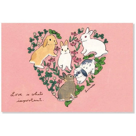 Share your love with this adorable postcard by Schinako Moriyama! This postcard features bunnies in the shape of a heart with the message "Love is What's Important".

4in x 5.8in