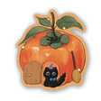 A small black kitty finding home in a persimmon.

Dishwasher safe
Size: 2.4” x 2.7”
Soft matte vinyl