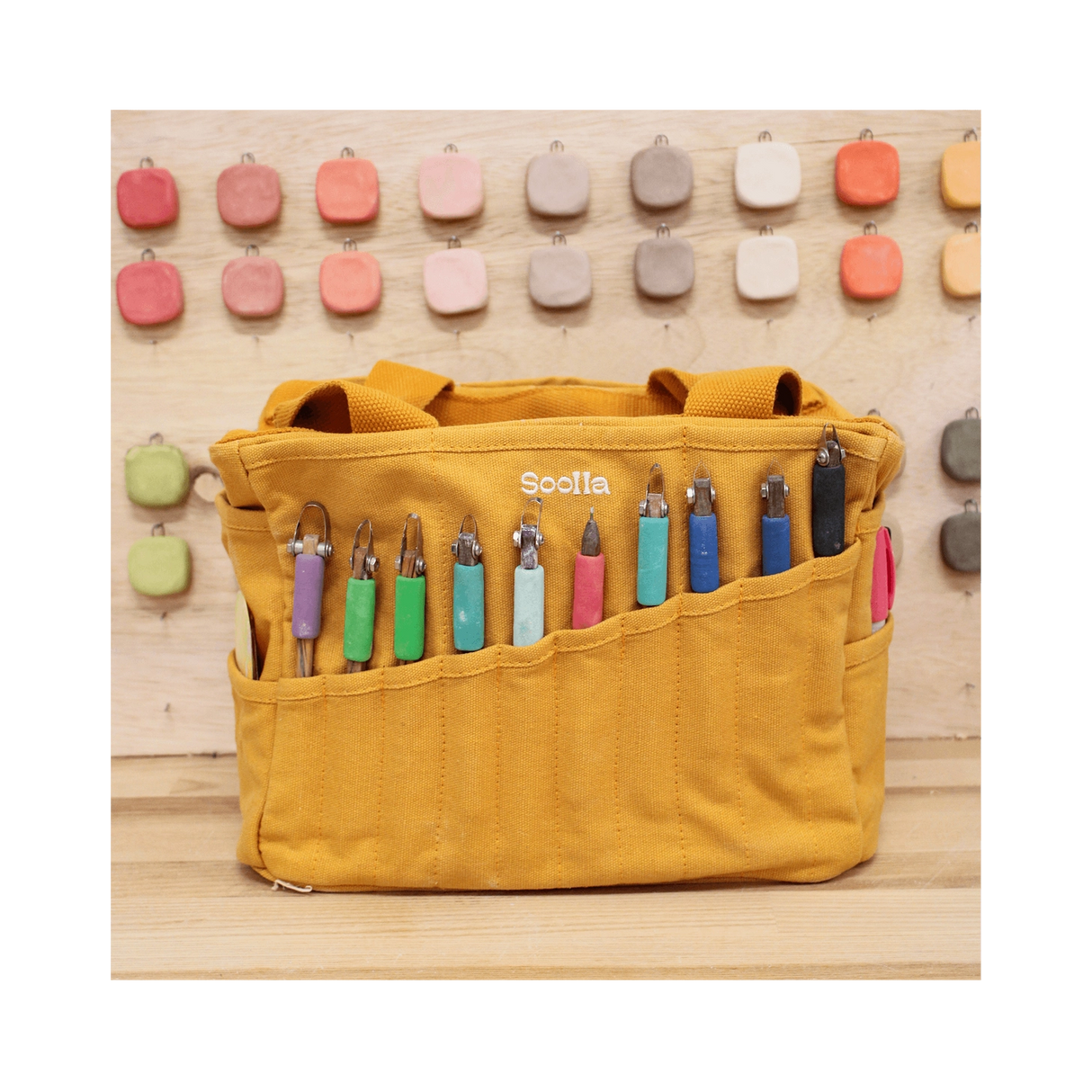 Your art is bold. Your bag should be too. The world's most loved art supply bag, pottery tool bag &amp; knitting project bag – backed by over 10,000 global artists!

✌️ 15 stunning colors ✌️

🌈 Over 30 Pockets Of Varying Sizes

🌈 Slanted Skinny Pockets : For your most-loved tools that beg for your attention (carving tools, knitting needles, crochet hooks

🌈&nbsp;Large Interior Storage + 2 interior pockets: Perfect for carrying glazes, knitting yarn, crochet supplies, and craft supplies

🌈 Phone &amp; Wa