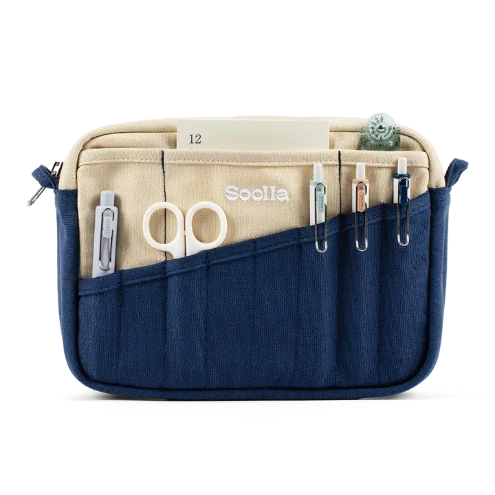 A compact carry-all pouch for artists, makers, and stationary lovers who appreciate a little order in their chaos. Structured enough to hold its form, soft enough to fit anywhere, and fully machine-washable for the days that get a little messy — your tools, pens, and creative essentials stay safe, visible, and ready wherever you go.

Inside, 20 pockets make space for art supplies, stationary essentials, and an A5 notebook, all secured by a smooth YKK zipper. Sized to fit within larger bags or carry on its o