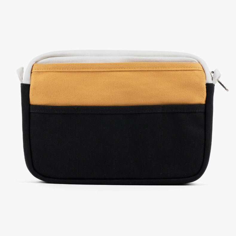 A compact carry-all pouch for artists, makers, and stationary lovers who appreciate a little order in their chaos. Structured enough to hold its form, soft enough to fit anywhere, and fully machine-washable for the days that get a little messy — your tools, pens, and creative essentials stay safe, visible, and ready wherever you go.

Inside, 20 pockets make space for art supplies, stationary essentials, and an A5 notebook, all secured by a smooth YKK zipper. Sized to fit within larger bags or carry on its o