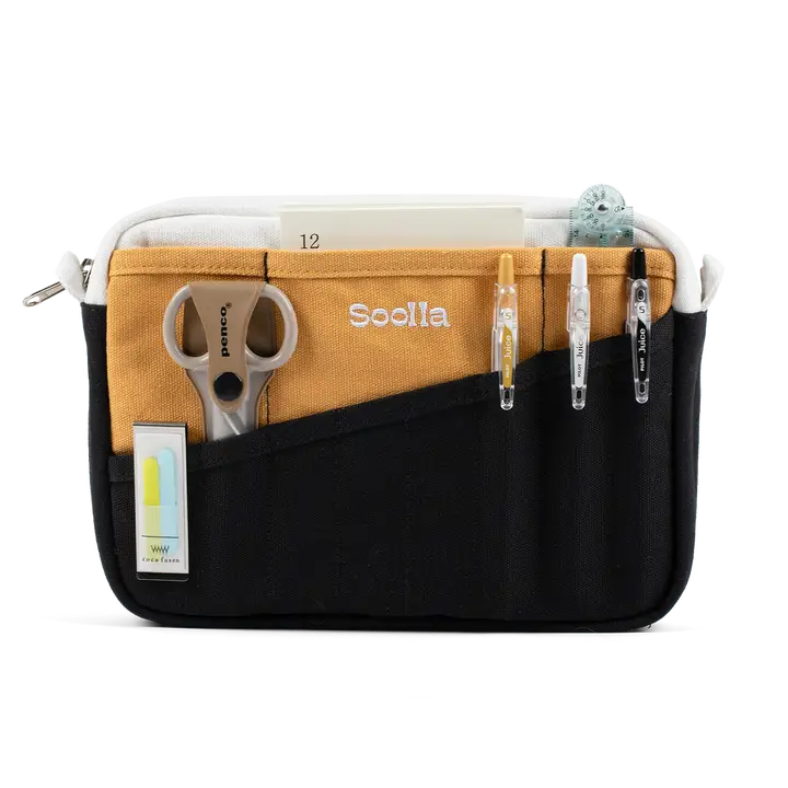 A compact carry-all pouch for artists, makers, and stationary lovers who appreciate a little order in their chaos. Structured enough to hold its form, soft enough to fit anywhere, and fully machine-washable for the days that get a little messy — your tools, pens, and creative essentials stay safe, visible, and ready wherever you go.

Inside, 20 pockets make space for art supplies, stationary essentials, and an A5 notebook, all secured by a smooth YKK zipper. Sized to fit within larger bags or carry on its o
