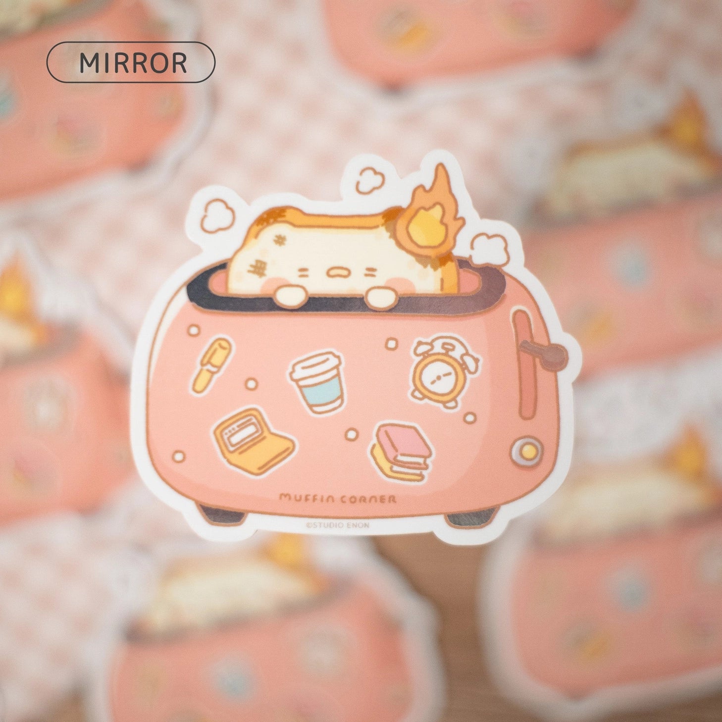 A sticker of burnt Muffinmaru toast feeling burnt out first thing in the morning. This sticker has a shiny mirror-like finish on some parts of the toaster for some extra flare. This durable sticker is great for decorating water bottles, laptops, suitcases, and much more!

Dimensions: 2.8" x 2.5" (7.1cm x 6.4cm)
Material: PET
Waterproof
Quantity: 1 sticker