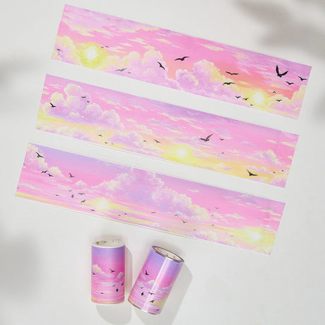 Capture the gentle embrace of evening with the Lotus Twilight Wide Washi/PET Tape. This tape embodies the softest part of the sunset. The design features a dreamy, seamless gradient that flows from a warm, glowing orange into a hazy, light lavender. Drifting through this pastel sky is a flock of silhouetted birds, gliding peacefully on the breeze. It brings a sense of calm and whimsy to your journal, perfectly replicating that quiet, cotton-candy sky moment just before the stars come out.