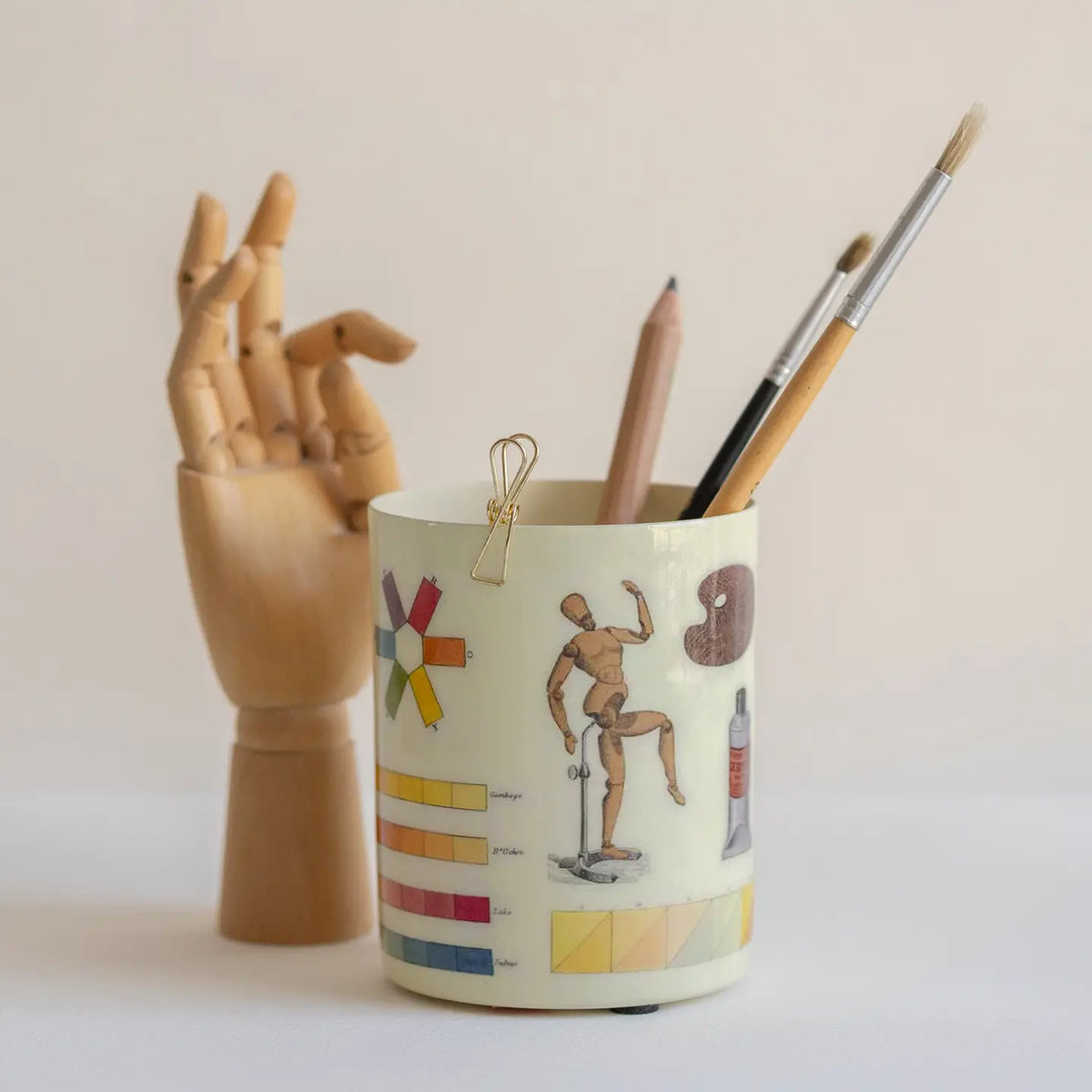 Handmade by skilled artisans, this decorative The Art of Colouring Enamel Everything Pot features artwork reproduced from a book about the art of colouring and painting landscapes in watercolours first published in 1805. Filled with colour swatches, artist studies, and drawing references, the design offers a fascinating glimpse into the tools and techniques used by early 19th-century painters and illustrators.

This food-safe enamel pot is wonderfully versatile—use it to hold pens and pencils, paint brushes