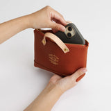 We made a miniature version of our engineer bag as a key case,and somehow, this one turned out a little bigger.

Still, the plump, playful leather pouch is fun to carry and somehow even looks delicious.

It’s sized to fit a paperback or an A6 notebook.

Size: W19.5×H12.5×D4.5cm
About the Leather – Japanese Glove Leather

Made from durable and supple Japanese glove leather, known for its lightness and strength.

Originally used for baseball gloves, this leather is highly resistant to friction and becomes sof