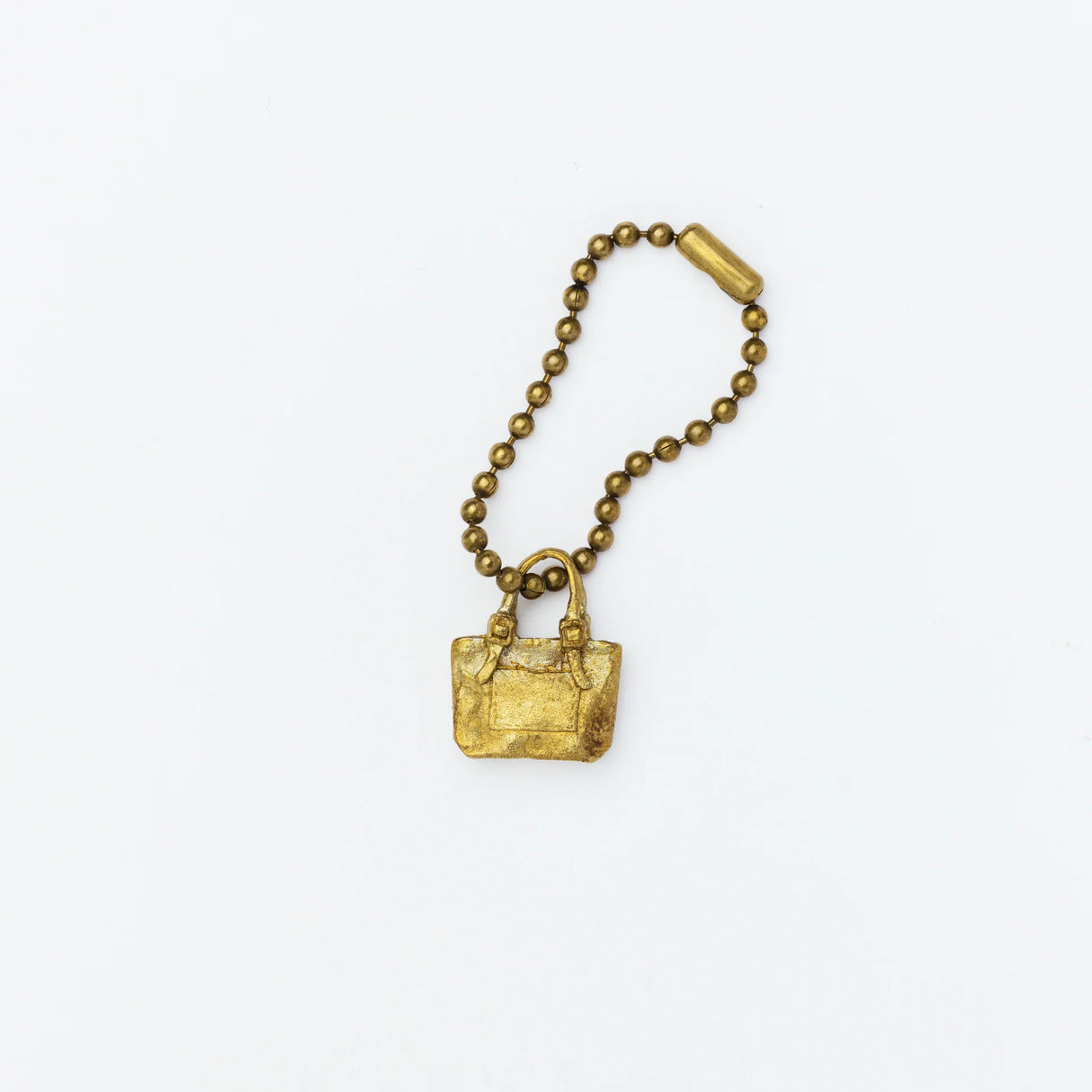 Brass charm in the shape of an engineer tote bag.

Equipped with a sleek ball chain, it attaches effortlessly to your bags, pouches, or key rings. Despite its petite size, it brings the distinct, rich texture and unmistakable presence that only genuine brass can provide.

As you use it, the brass will develop a natural patina over time—enjoy the changing character that comes with age.

Color: The color you see on your screen may differ from the actual product.

Brass Products

Due to the nature of brass, so