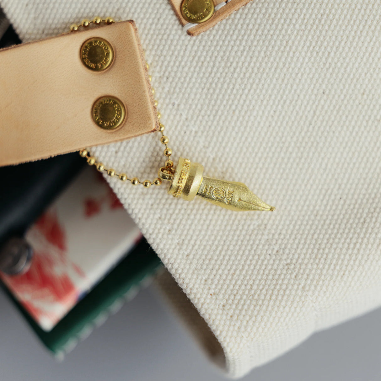 A Fountain Pen Nib Charm: Carried with Meaning

A solid brass charm meticulously shaped in the likeness of a classic fountain pen nib. Every intricate detail is beautifully captured, complete with the inspiring engraved message, "The Pens Will Be With You Always."

Equipped with a sleek ball chain, it attaches effortlessly to your bags, pouches, or key rings. Despite its petite size, it brings the distinct, rich texture and unmistakable presence that only genuine brass can provide.

As you use it, the brass