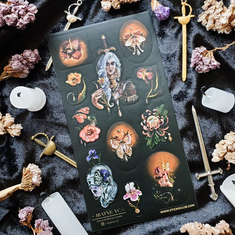 In @iratxe.yc’s shadowed garden, nothing is quite as it first appears. Jeweled flowers gaze back from curling stems, delicate moths wear watchful eyes, and a silver-haired guardian stands adorned in blossoms, gemstones, and armor. Rich with surreal beauty and dark botanical magic, this striking sheet reveals a forest where every petal may be hiding a secret.

Art by: @iratxe.yc

One sticker sheet is included.
Top Coating: None
Adhesive Layer: Paper
Backing Layer: Clear PET
Size:6.69"x3.54"
Weight-0.03oz
