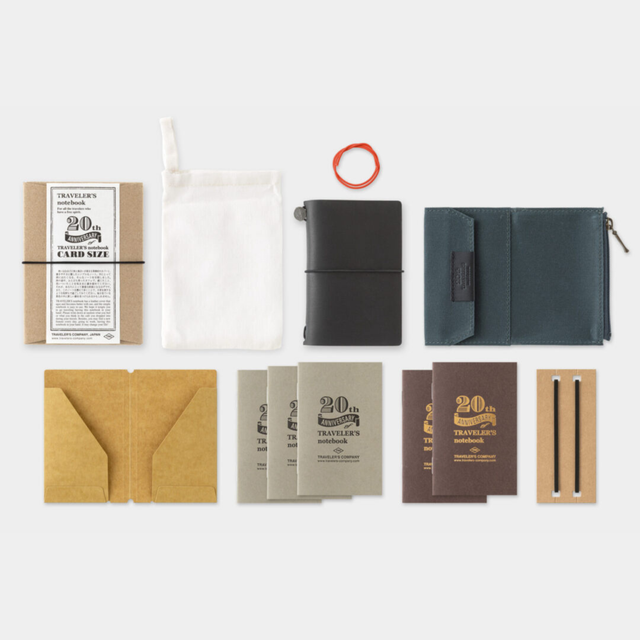 To commemorate this 20th anniversary, we’ve created a new size of TRAVELER’S notebook.

It is TRAVELER’S notebook Card Size. This TRAVELER’S notebook is always with you, even in your daily life. Whether it’s a sudden idea, information you learned or overheard, or something important you don’t want to forget— whenever and wherever you feel like writing, you can quickly grab the notebook and jot it down.

This set includes TRAVELER’S notebook Card Size, Refill Notebooks, Cotton Zipper Case, Kraft Paper Folder
