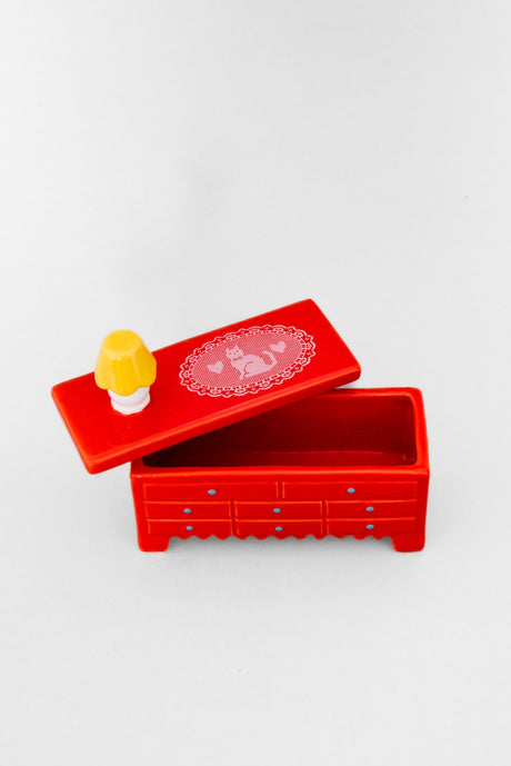 Put your trinkets in this tiny dresser with this tiny little lamp on top. You’ll feel like a doll in the tiniest little doll house. Trust us, we’ve tried it. Highly recommend.&nbsp;